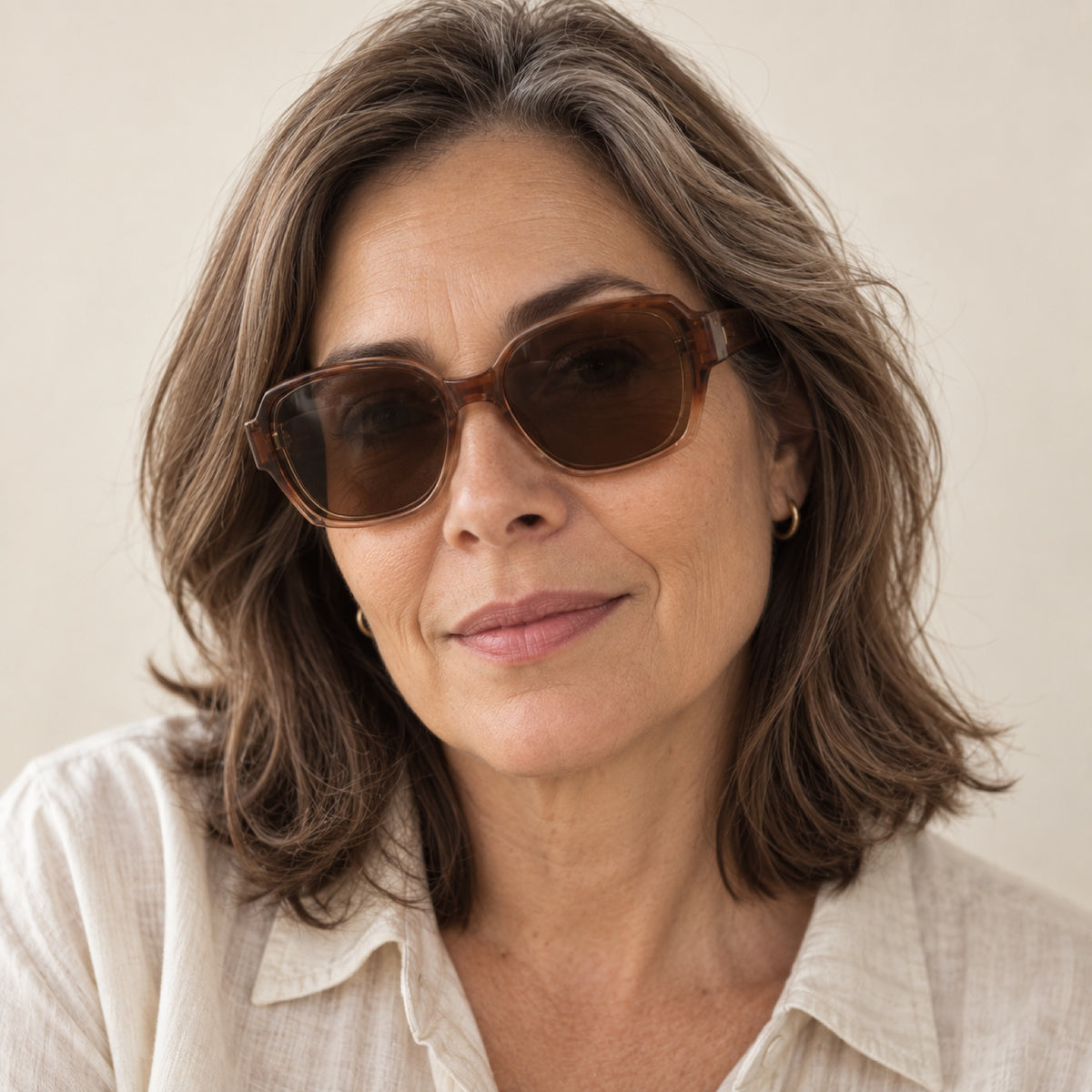 Mujer de unos 50 años usando los lentes de sol Solzia color café